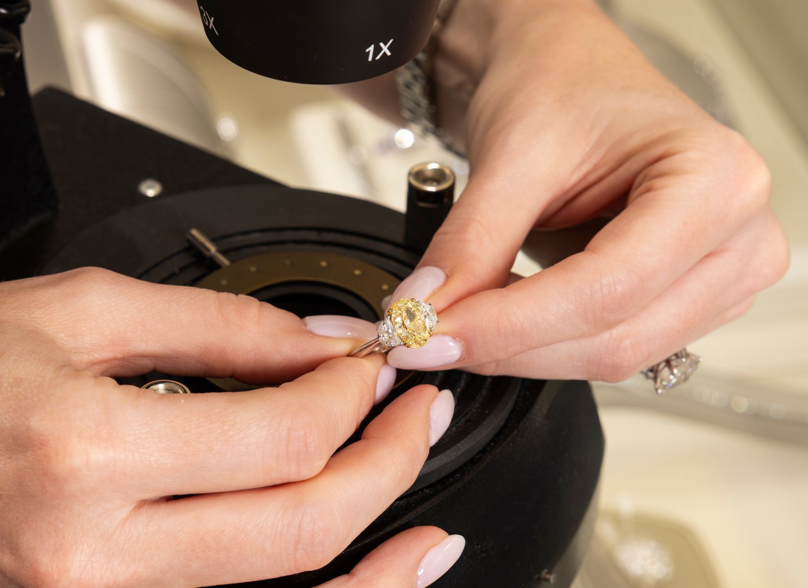 A Perry&rsquo;s gemologist examining a yellow diamond ring