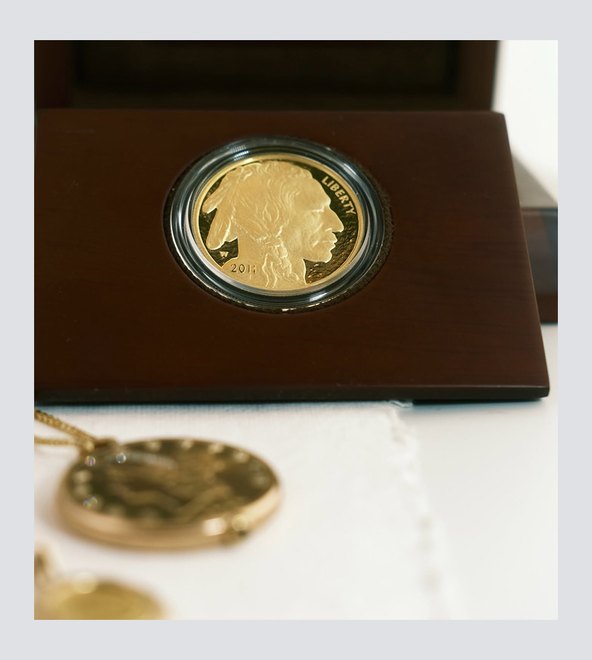 Gold and silver coins in a collector&rsquo;s tray